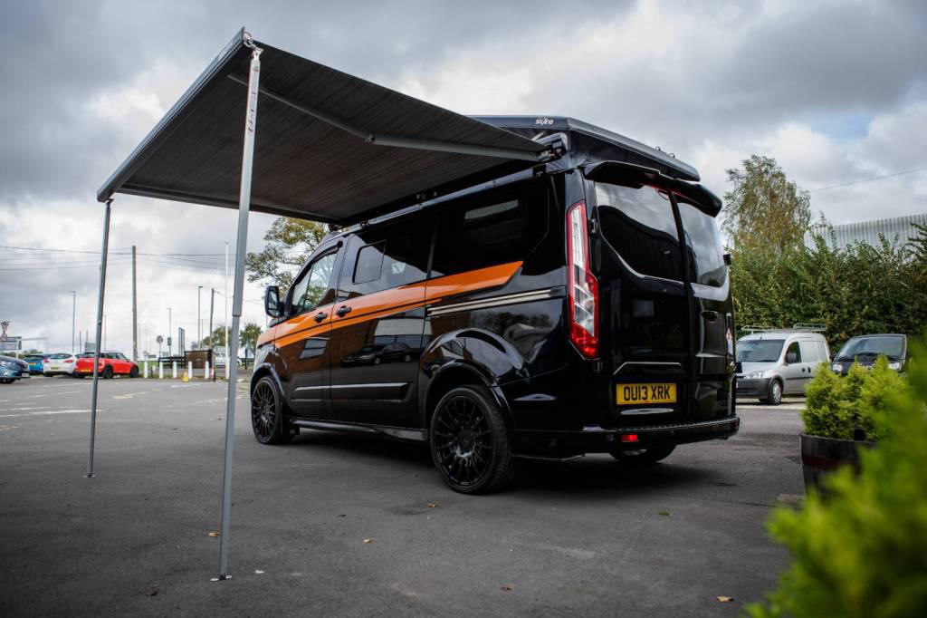A black Ford Transit Custom Campervan converted by Somerset Campervan Company